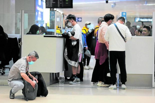 Tourists from China are interviewed by immigration officers as they arrive at NAIA. STORY: House panel sets VAT refund scheme for foreign tourists