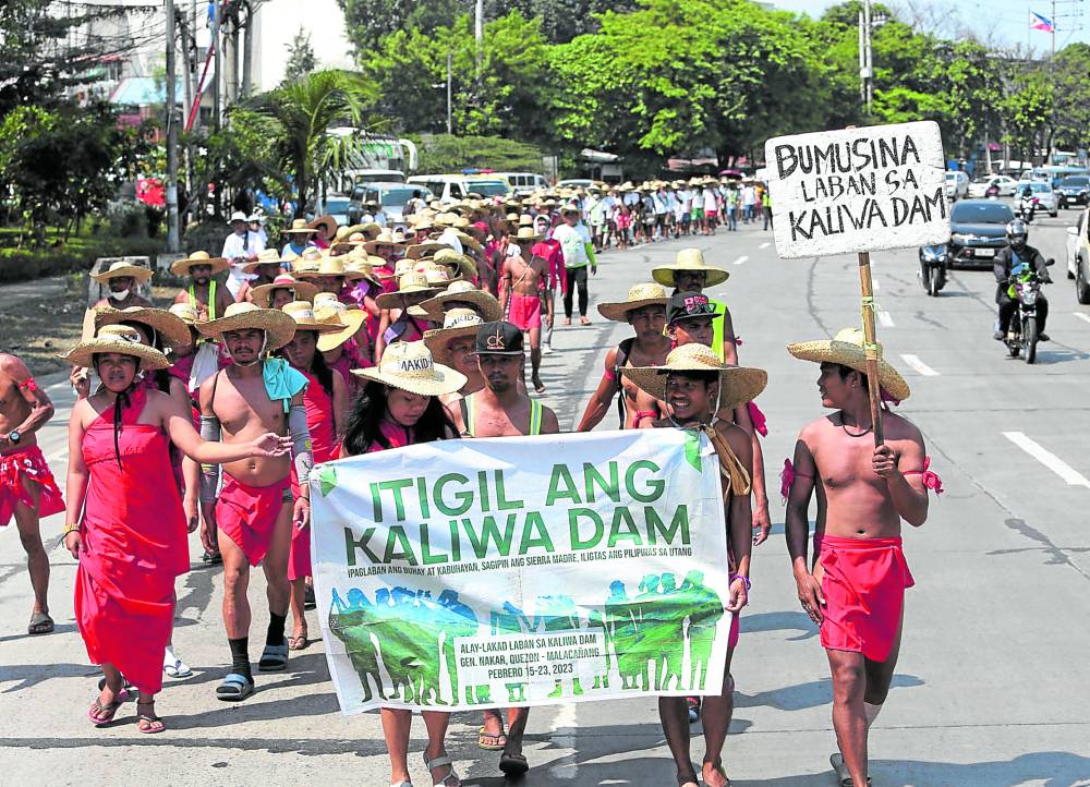 About 300 members of the Agta indigenous community from Quezon province march along the Quezon Memorial Circle in Quezon City on Friday on their way to Malacañang to protest against the construction of the Chinese-funded Kaliwa Dam project that will inundate their ancestral homes.