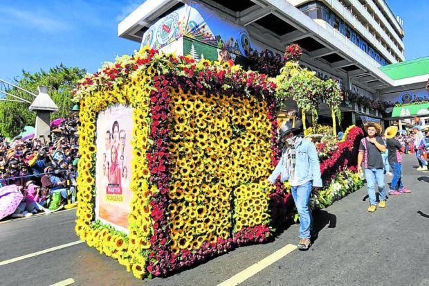 MARCOS MEMORIES A box-shaped flower bedecked float joins Baguio City’s Panagbenga (flower festival) parade on Sunday as it promotes the movie “Martyr or Murderer,” about the exile of the Marcoses and the aftermath of the Edsa Revolution from their perspective. —WILLIE LOMIBAO