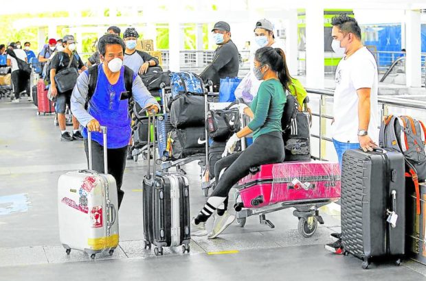 BOARDING  Passengers line up at  Ninoy Aquino International Airport Terminal 2 to check in for their respective flights out of the country. —FILE PHOTO