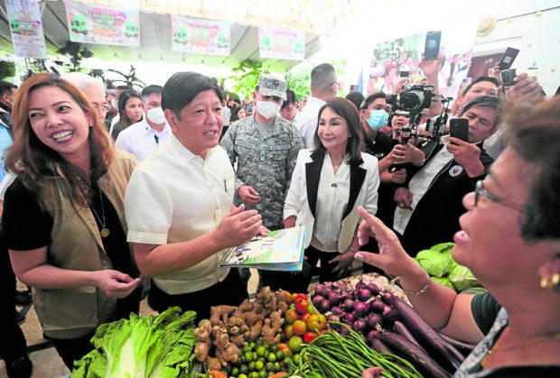 ‘KADIWA NG PANGULO’ President Marcos talks to a vendor during a visit to the Kadiwa caravan set up at the Cebu provincial capitol grounds on Monday. —MARIANNE BERMUDEZ