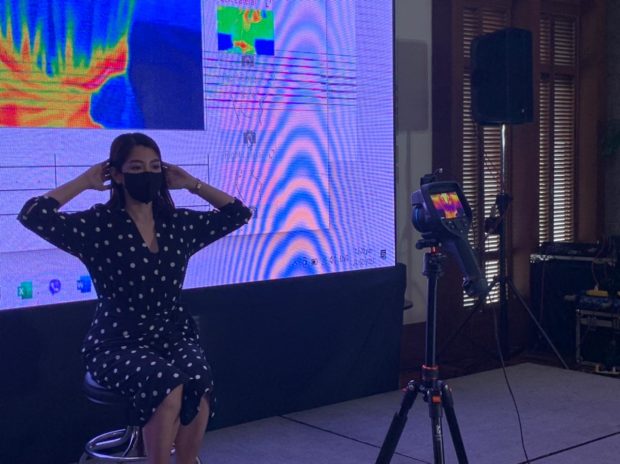A woman demonstrating how to use the thermal testing machine for breast cancer during a forum in Makati City. The diagnostic tool uses a high resolution thermal sensing device and a cloud hosted analytics solution which would analyze the thermal images. (Photo from John Eric Mendoza)