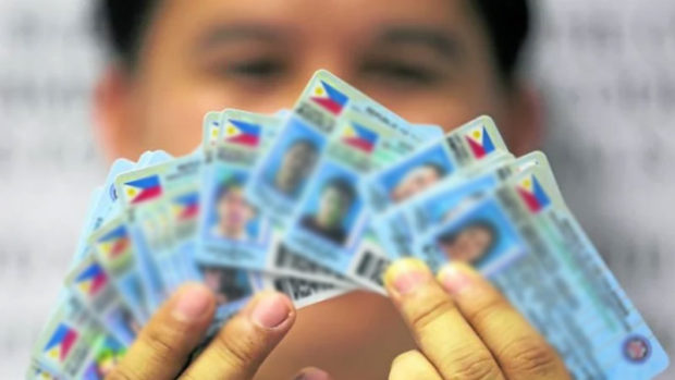 An employee of the Land Transportation Office shows some driver’s licenses that have yet to be distributed.