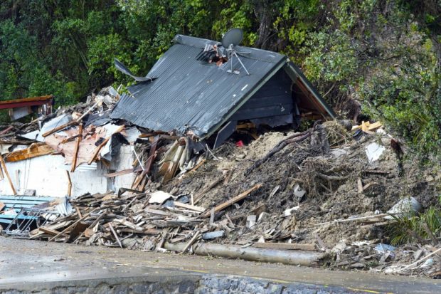A general view of a damaged house after a storm battered Titirangi, a suburb of New Zealand's West Auckland area, on February 13, 2023. - Thousands of homes in New Zealand were without power and flights were grounded Monday as a tropical storm lashed the north of the country. (Photo by Diego OPATOWSKI / AFP)