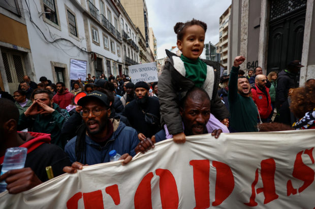 People shout slogans during a demonstration against the mounting costs of living, in Lisbon, Portugal, February 25, 2023.