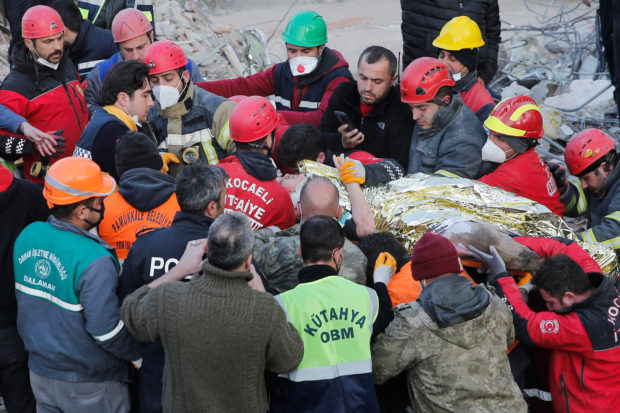 Rescuer workers carry Kaan, a-13-year old Turkish teenager, to an ambulance after being rescued from the rubble after 182 hours, in the aftermath of a deadly earthquake in Hatay, Turkey February 13, 2023. REUTERS/Dilara Senkaya