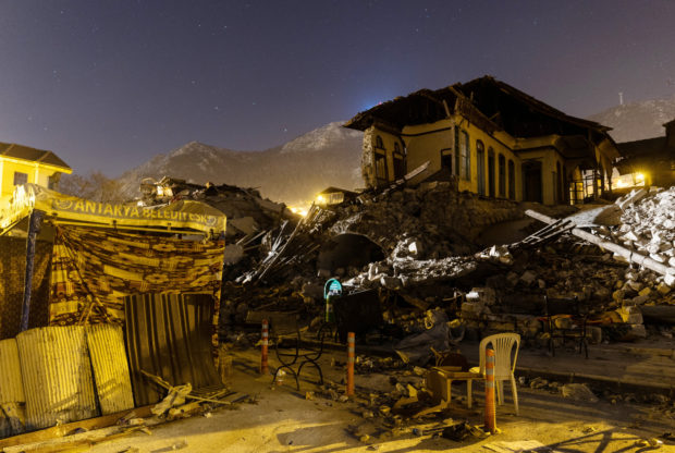 Destroyed buildings are seen at night in the aftermath of a deadly earthquake in Antakya, Turkey February 19, 2023. 