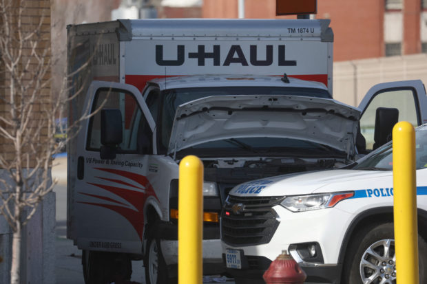 A New York Police Department vehicle blocks a U-Haul rental vehicle, in the Brooklyn borough of New York City