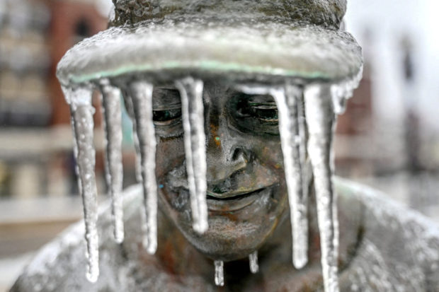 Icicles hang from the hat of a figure that is part of the Hometown Hero baseball sculpture outside Jackson Field