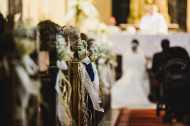 Stock photo of couple at altar in a church wedding. STORY: ‘Cost’ making couples forgo church wedding – poll