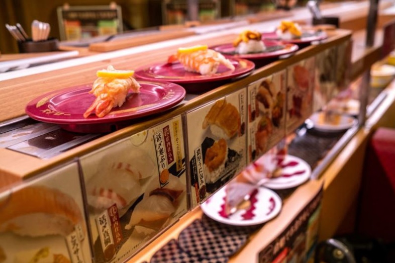 This picture shows plates of sushi on a conveyor belt at a sushi chain restaurant in Tokyo on Friday
