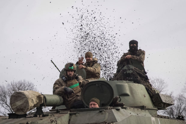 FILE PHOTO: Ukrainian service members ride a self-propelled howitzer, as Russia's attack on Ukraine continues, near the frontline city of Bakhmut, Ukraine February 27, 2023. REUTERS/Yevhen Titov