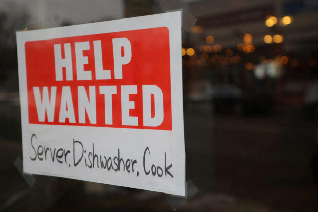 FILE PHOTO: A “Help Wanted” sign hangs in restaurant window in Medford, Massachusetts, U.S., January 25, 2023.     REUTERS/Brian Snyder/File Photo