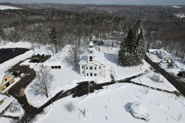 Snow from a recent nor'easter storm covers the town common and the First Parish Church in Ashby, Massachusetts, U.S., March 15, 2023.     REUTERS/Brian Snyder