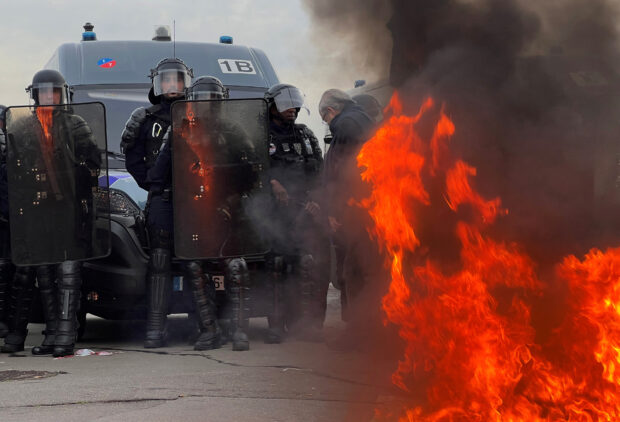 Police fire tear gas at protesters on the Place de la Concorde in Paris, where some 7,000 people demonstrated against the government's pension changes in a spontaneous and unplanned rally.