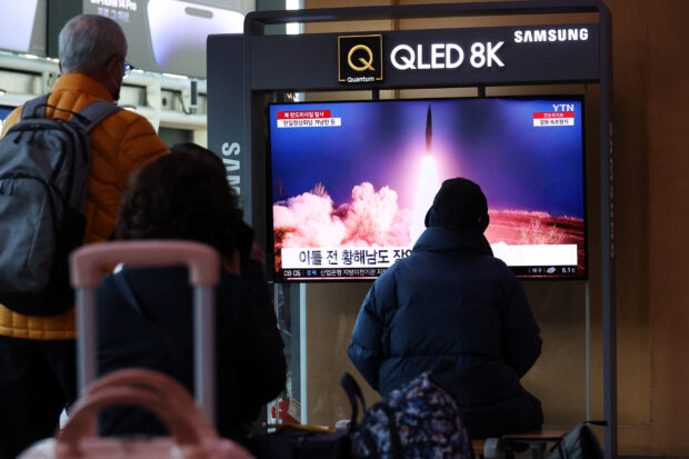 People watch a TV broadcasting a news report on North Korea firing a ballistic missile into the sea off its east coast, at a railway station in Seoul, South Korea, March 16, 2023.   REUTERS/Kim Hong-Ji