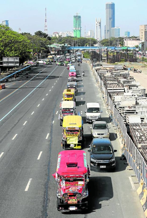 A protest caravan of jeepneys on Commonwealth Avenue in Quezon City. 