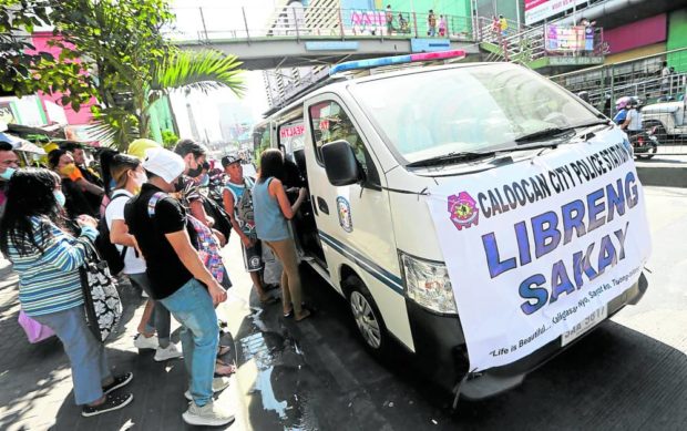 A service vehicle of the Caloocan City police offers free ride to stranded commuters on Samson Road in Balintawak, Quezon City, on Monday, the first day of a weeklong transportation strike staged by jeepney drivers and operators against the public utility vehicle modernization program. STORY: Strike fails to paralyze public transport – MMDA