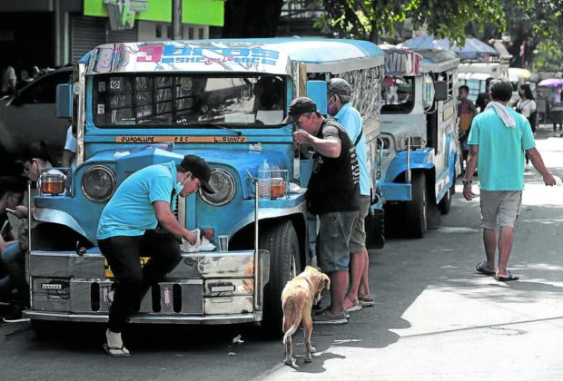Jeepney drivers take a break to eat their lunch at the intersection of Agoncillo and Pedro Gil in Manila during the transport strike. STORY: Organizer of transport strike claims success; MMDA disagrees