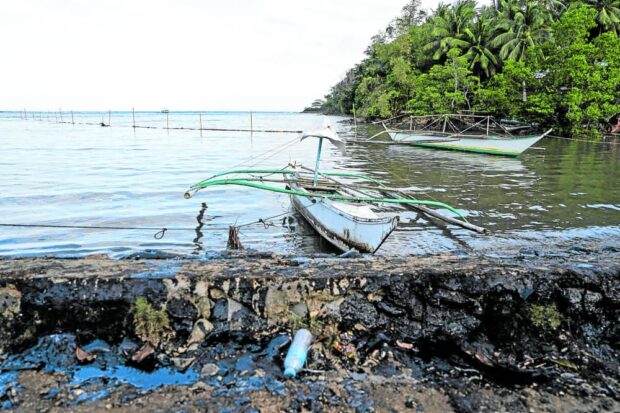 Fishing boats are left idle along the shoreline of Pola, Oriental Mindoro in this photo taken on Thursday, March 9, 2023, following the widespread oil spill that affects the livelihood of local fishermen. STORY: Mindoro oil spill victims reach 19,000