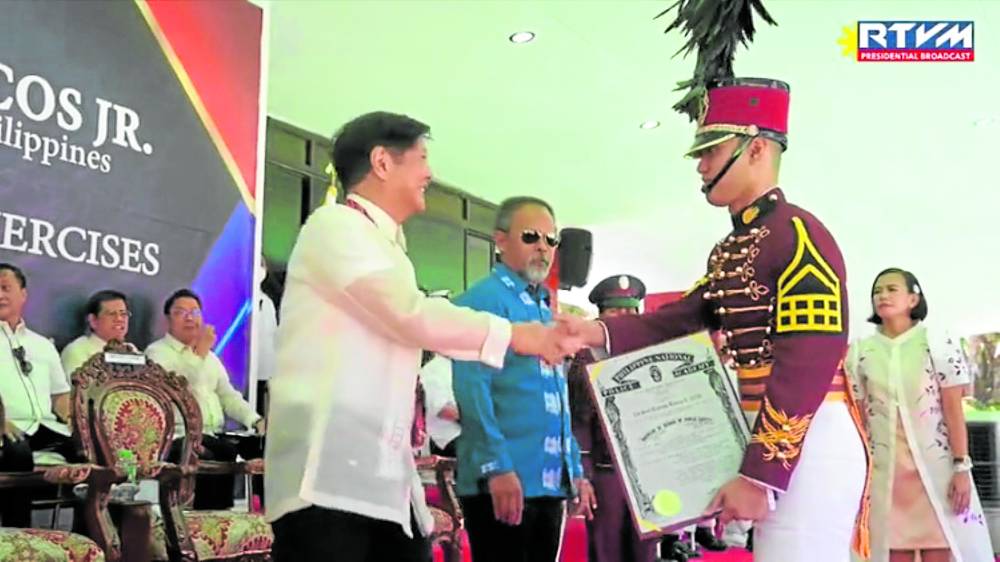 Marcos congratulates cadet Seal Bantag during the commencement rites of the Philippine National Police Academy