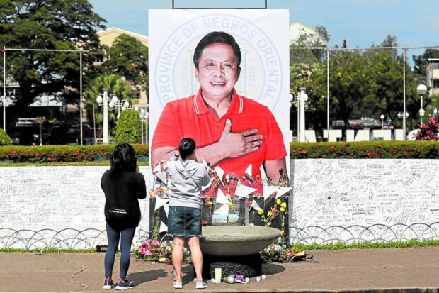 On the capitol grounds, others offered flowers in front of a large portrait of the slain official degamo suspect pnp killing