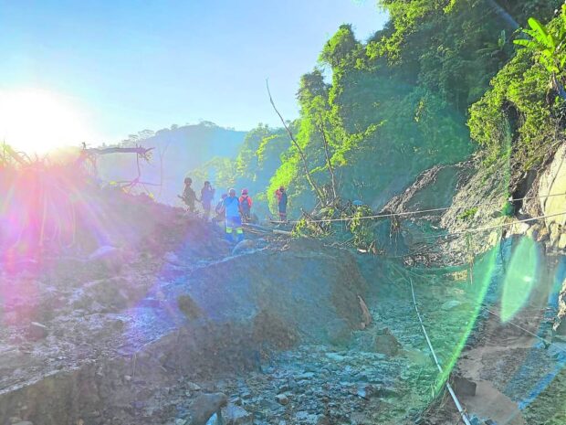 There used to be a road here. But this portion of Tagbaros-Mainit road in Maco, Davao de Oro, is now closed to traffic, in this photo taken Tuesday, after a landslide triggered by heavy rains since Monday night struck the area. STORY: Residents flee floods, landslides in Davao de Oro