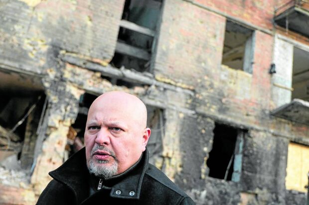 International Criminal Court (ICC) Prosecutor Karim Khan visits a residential building damaged by a Russian missile strike late November 2022 in the town of Vyshhorod, outside Kyiv, Ukraine