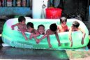 NO BEACH, NO PROBLEM Children enjoy a dip in an inflatable pool on Pasong Tirad in Makati City in this photo taken last week as the weather bureau declared the beginning of the dry season. Officials have also warned about the impact of El Niño on water supply as the heat index continues to rise in different parts of the country. —MARIANNE BERMUDEZ