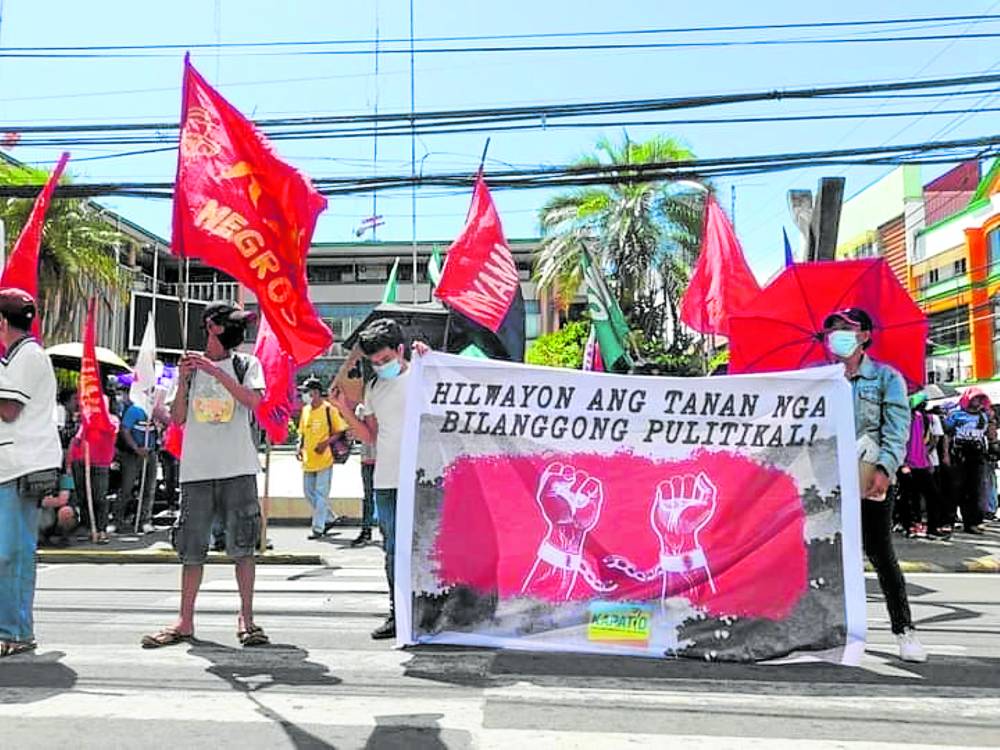 Protesters demand the release of allpolitical prisoners during a rally staged in Bacolod City during the 50th anniversary of the declaration of martial lawon Sept. 21, 2022
