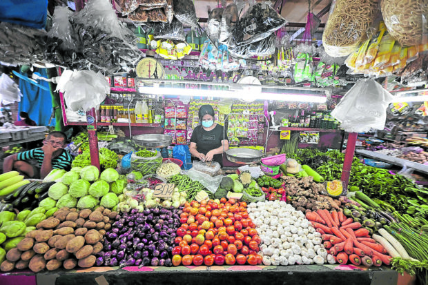 A vendor tends to fresh vegetable produce at a stall in Mega Q Mart in Cubao, Quezon City on Thursday, March 2, 2023. STORY: Gov’t ramps up measures to tackle high inflation