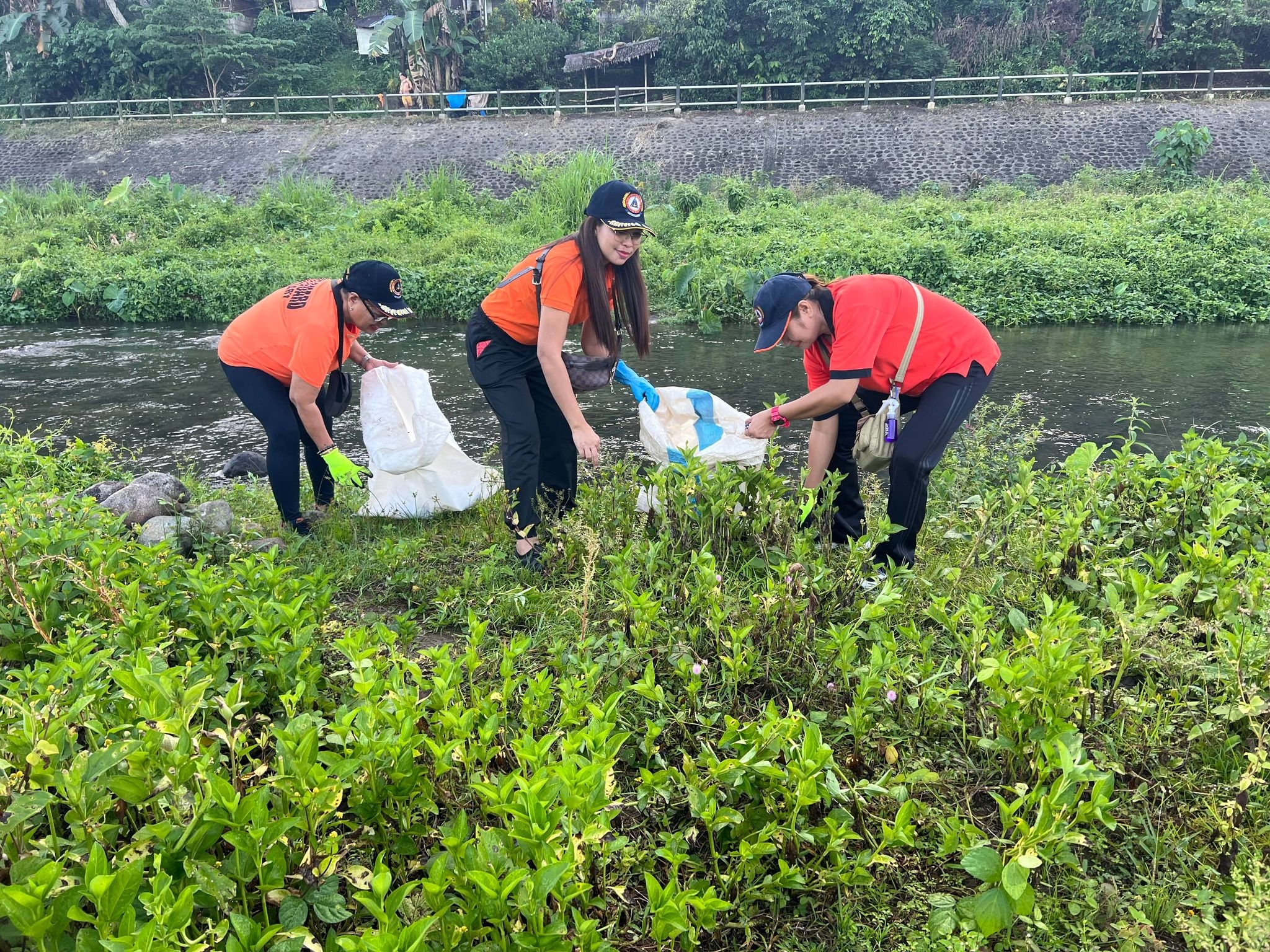 Members of the Philippine Coast Guard (PCG) clean the Malbasag River in Ormoc City as part of the celebration of the 60th Earth Day on Saturday, March 25.