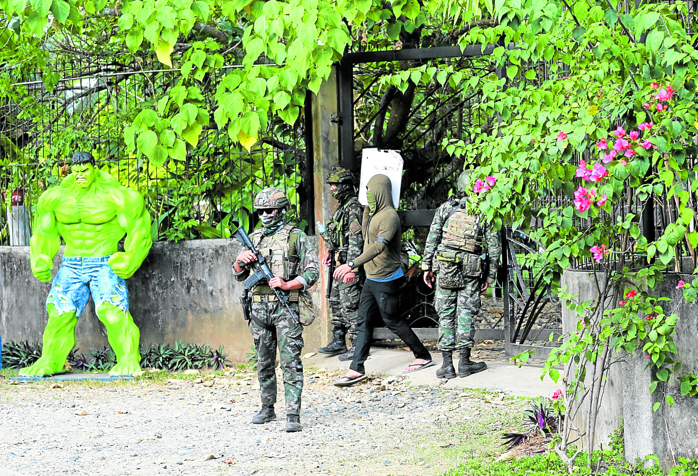 Agents of the Criminal Investigation and Detection Group guard a house, one of several properties in Negros Oriental belonging to Rep. Arnolfo “Arnie” Teves Jr., during a raid on Friday in search of loose firearms