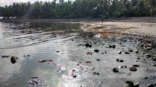 The shoreline of Pola, Oriental Mindoro, is covered with thick and black oil that leaked from the sunken MT Princess Empress as seen in this photo taken in one of thetown’s coastal villages on March 4, 2023. STORY: Oil spill puts 8 more towns in Oriental Mindoro in calamity state