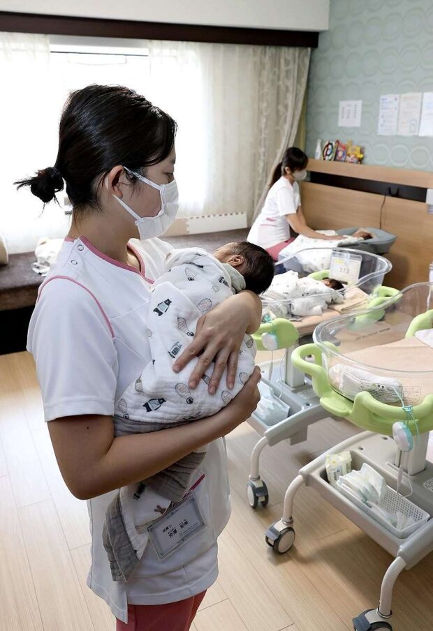 A staffer cares for a baby at a hotel in Chiyoda Ward, Tokyo, on March 2.