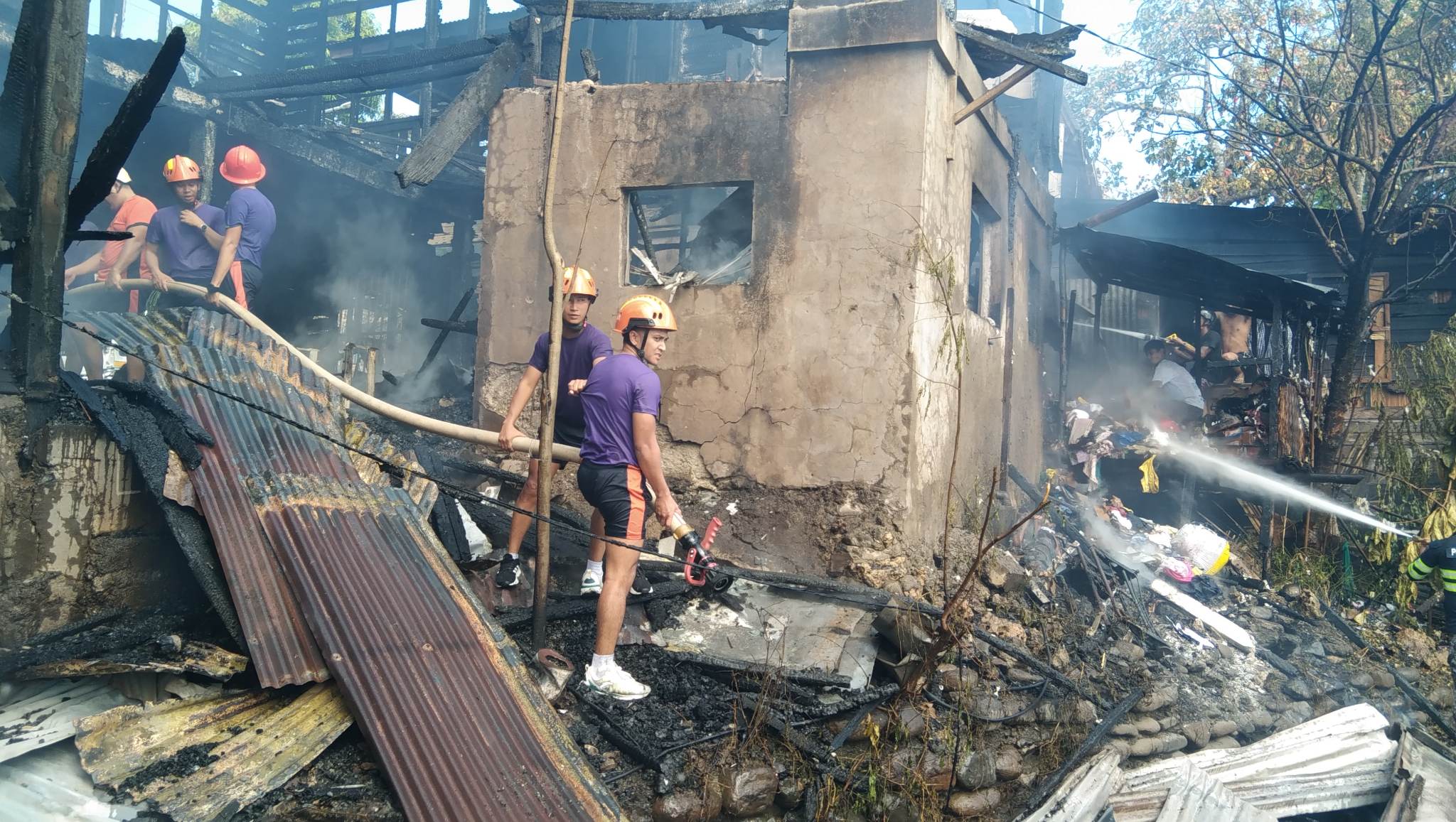 Firemen attempt to douse the fire that hit 20 houses spread between three villages in Puerto Princesa City in Palawan province on Wednesday, March 8