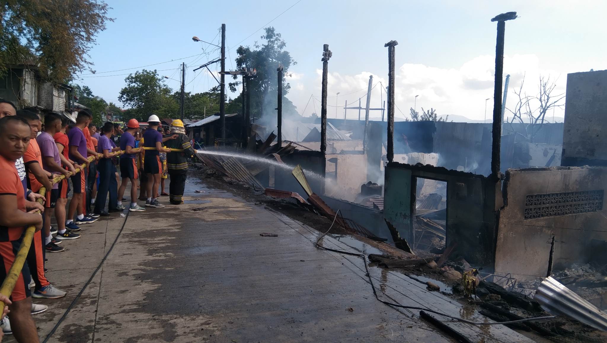 Firemen attempt to douse the fire that hit 20 houses spread between three villages in Puerto Princesa City in Palawan province on Wednesday