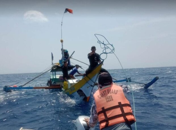 Personnel of the Coast Guard Sub-Station-Santa Ana rescue the four crew members of MB Kiray, which was swamped with water near Palaui island in Santa Ana town, Cagayan province on Monday, March 20. (Photo courtesy of PCG-District North East Luzon)