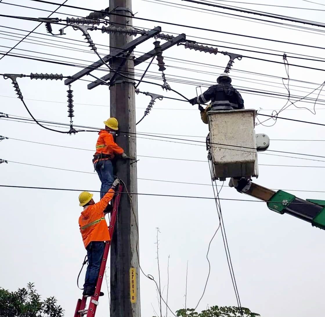 Field workers of the San Fernando Electric Light and Power Company repair power lines in Pampanga's capital city
