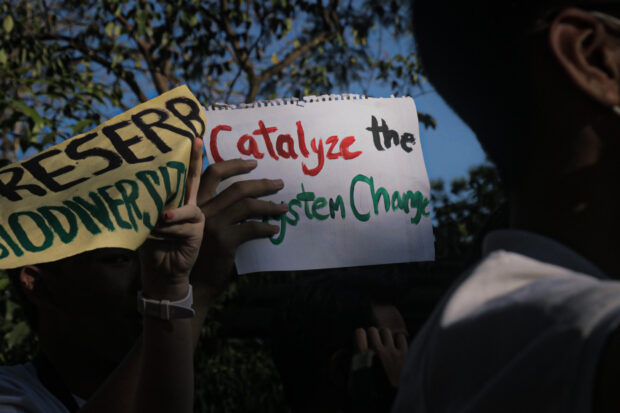 Groups stage a protest action at UP Diliman against ongoing land reclamation projects of the government