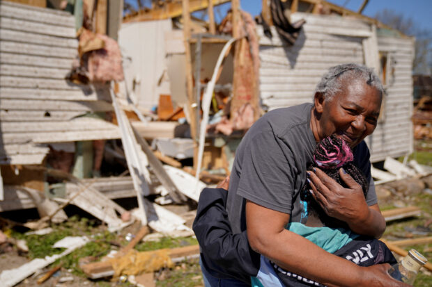 Ester Johnson-El, 62, embraces her great granddaughter She-Keelie, 6, in front of the wreckage of her home after seeing each other for the fist time since the tornado, after a monster storm system tore through the South and Midwest on Friday, in Wynne, Arkansas, U.S. April 1, 2023. REUTERS/Cheney Orr