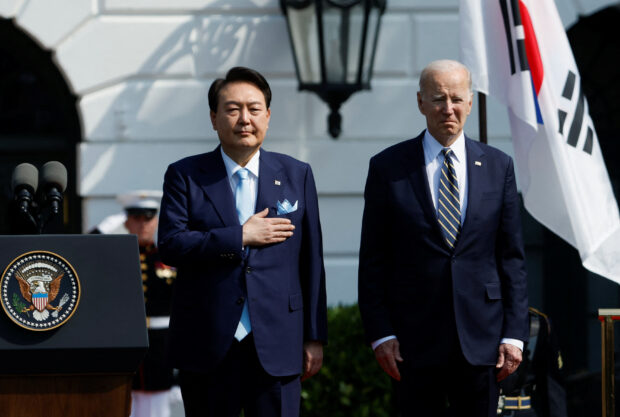 U.S. President Joe Biden and South Korea's President Yoon Suk Yeol stand on stage together during an official White House State Arrival Ceremony on the South Lawn of the White House in Washington, U.S. April 26, 2023. REUTERS/Jonathan Ernst