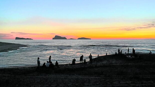 SUNSET WATCHERS   Tourists watch the sunset in San Miguel, San Antonio, Zambales, on Saturday. The waters off the coastal village are within the area that the Philippine Space Agency says people may find floating debris from a Chinese rocket launched on Friday. —JOANNA AGLIBOT 