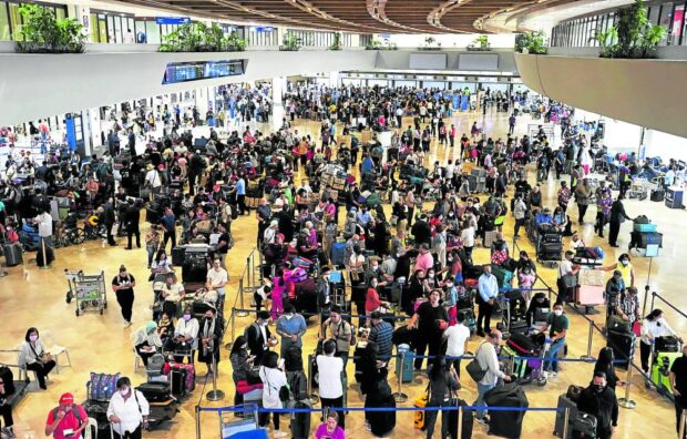 The Ninoy Aquino International Airport’s Terminal 1 is packed with passengers on March 29, 2023. days before the expected travel rush during Holy Week.  STORY: Go to airports early, Holy Week travelers urged
