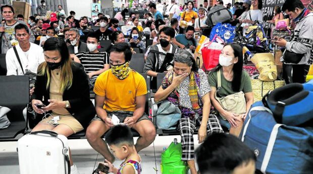MASK ON People heading to their home provinces for the recent Holy Week break wait for buses at Parañaque Integrated Terminal Exchange in Parañaque City. Many of them wear masks to comply with health and safety protocols in public transport. —RICHARD A. REYES