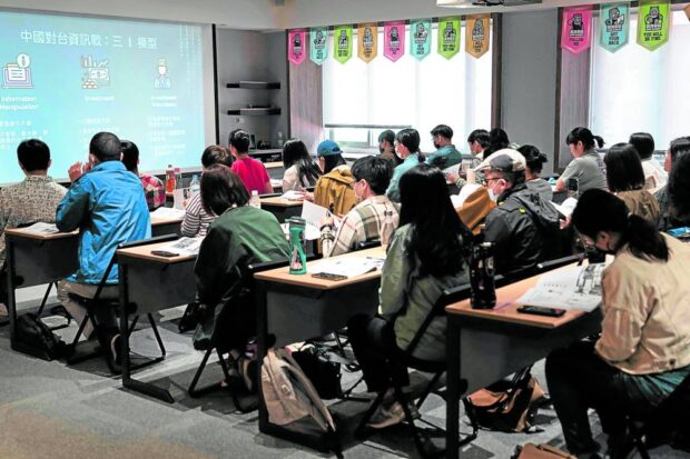 Civilians who wish to learn simple defensive strategies in the event of a Chinese invasion of Taiwan attend daylong courses, like this one conducted at the Kuma Academy in Taipei on April 16. Slots for such classes were sold out in minutes after they were announced. STORY: Taiwan civilians train to face Chinese threat of hybrid warfare