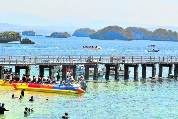 Tourists enjoy island-hopping and other water activities at Hundred Islands National Park in Alaminos City, Pangasinan, in this photo taken last month. Tourism is seen to benefitas Pangasinan prepares to build more roads and seaports and improve its transportation hubs through a government loan. landbank