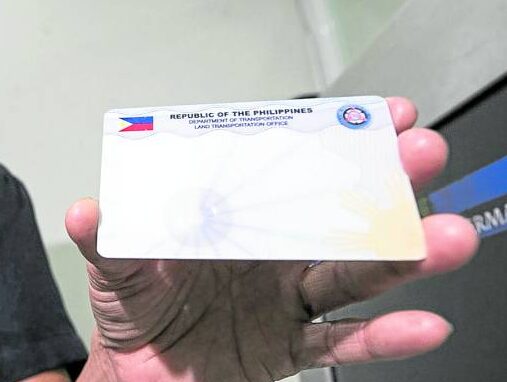 Administrative Aide IV Raquel Maniago shows a blank PVC ID from a set intended for driver’s licenses. The government, however, has run out of supply of the plastic cards.