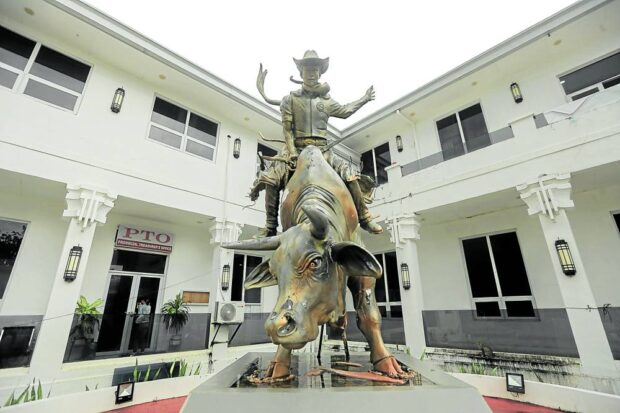 A concrete statue of a cowboy riding a bull,unveiled in 2017, honors the culture of Masbate as the “rodeo capital of the Philippines” at the provincial capitol grounds in Masbate City.