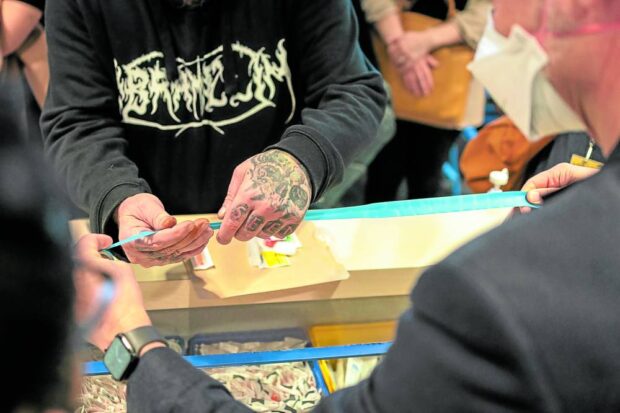 A drug user (top left) is allowed to use his drug injecting paraphernalia (center) inside a medically supervised room on the sidelines of the Harm Reduction International Conference 2023 in Melbourne, Australia, on April 15.